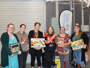 Group of people standing with donated toys